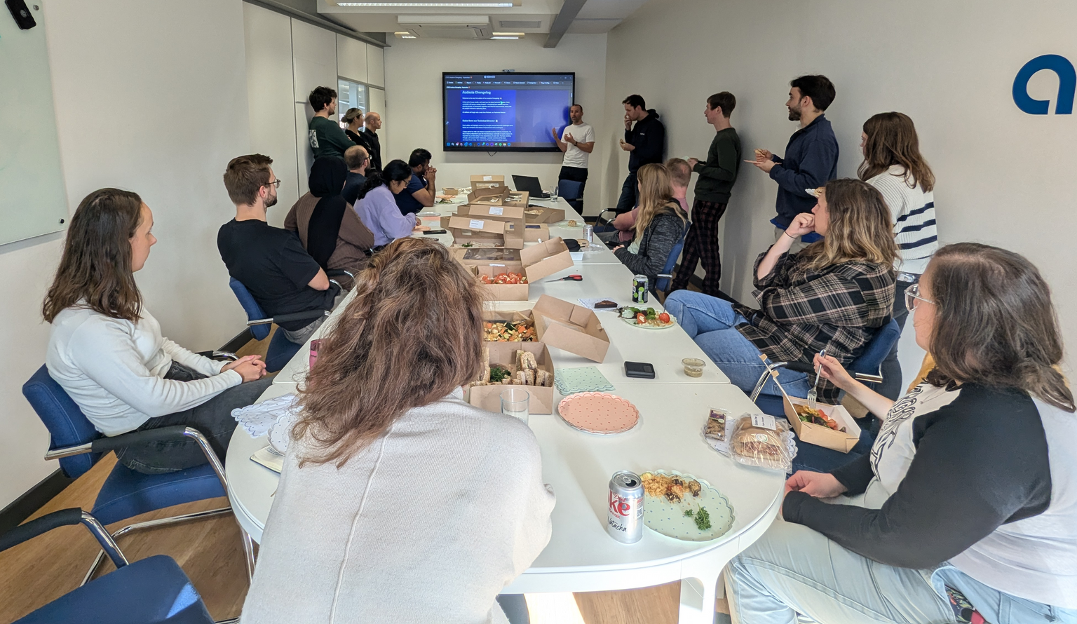 Colleagues collaborating at their desks